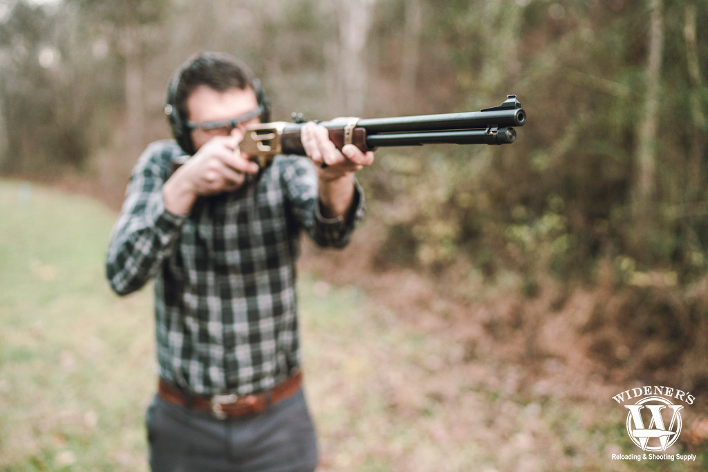 a photo of a man shooting a 30-30 lever action rifle
