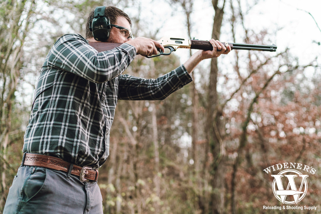 a photo of a man shooting a 30-30 lever action rifle