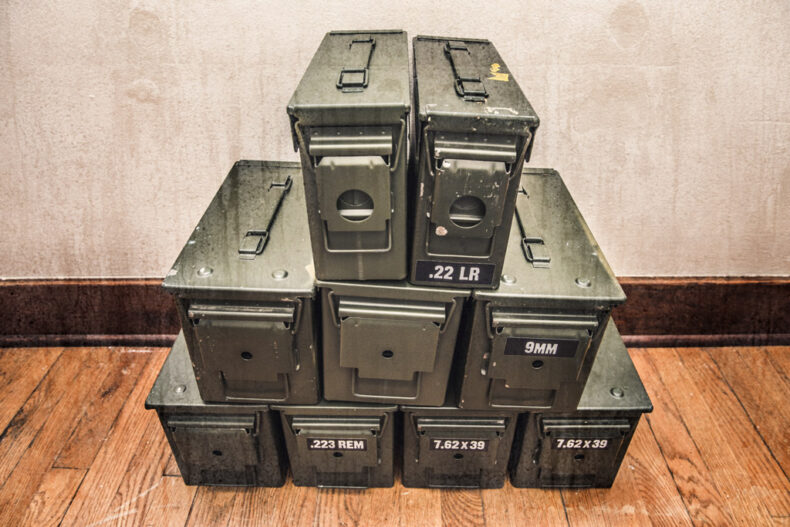 photo of ammo storage boxes stacked on a wooden floor