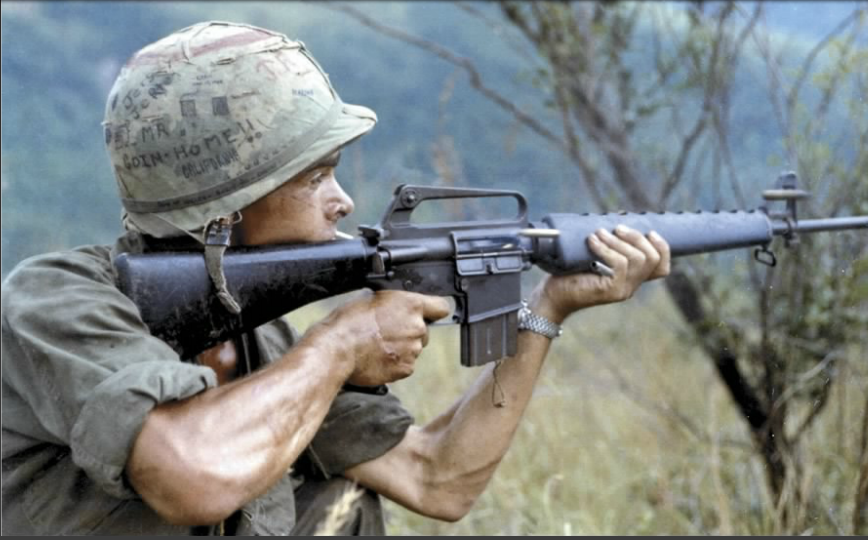 photo of vietnam war US soldier firing an m16 rifle