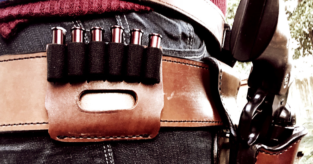 a photo of A leather slide with 5 bullet loops for holding rifle ammo at a Cowboy Action Stage