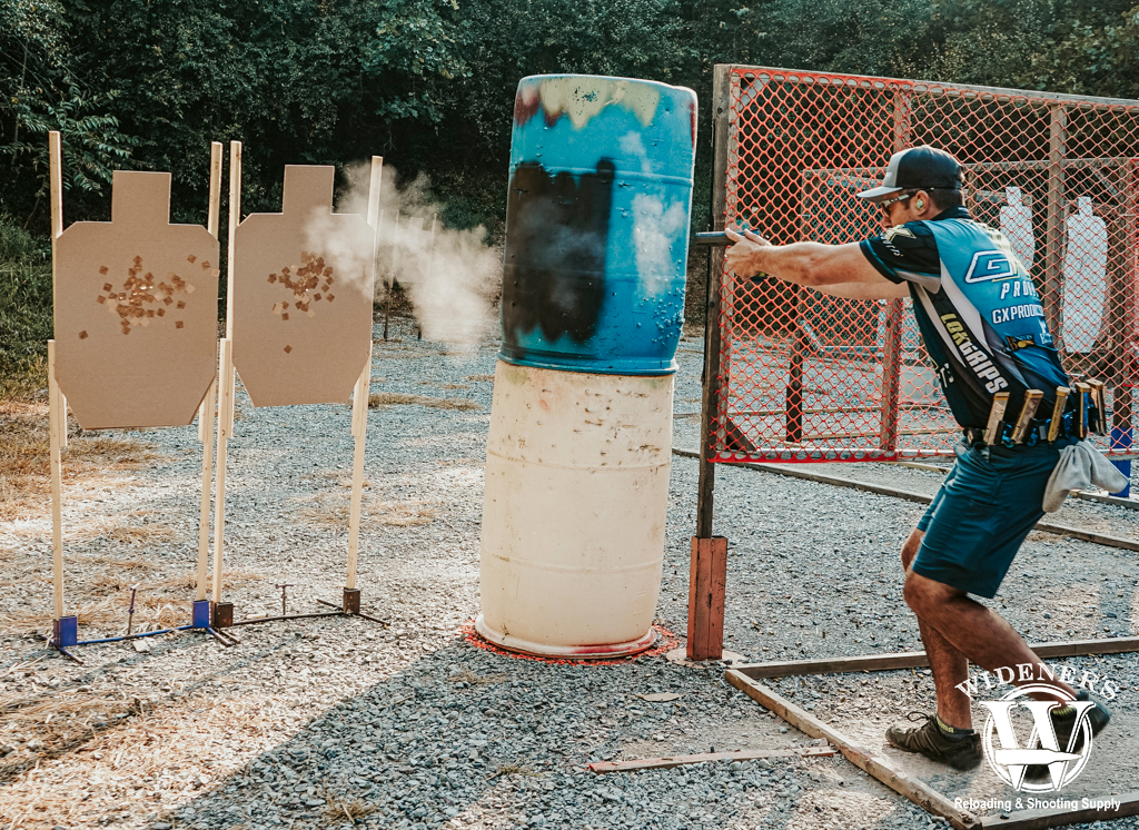 a photo of a man shooting a uspsa match