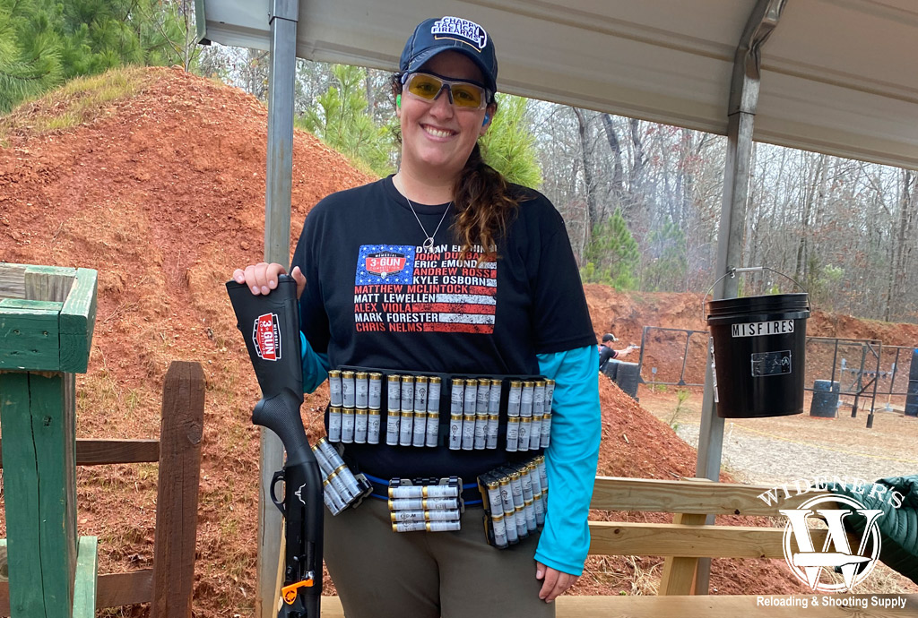 a photo of a female 3 gun competition shooter with 12 gauge shotgun