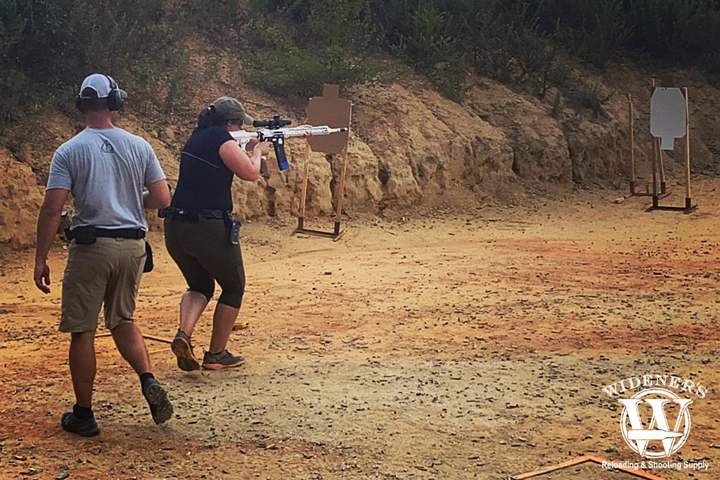 a photo of a female shooting a competition rifle