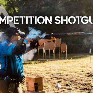 a photo of a woman shooting a competition shotgun