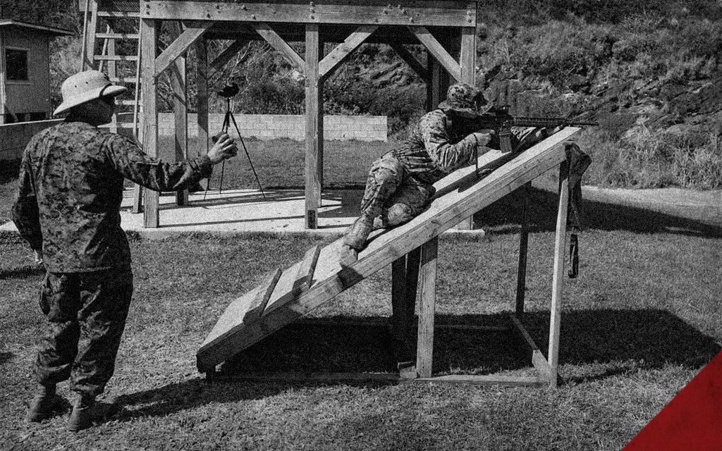 man shooting a rifle from a platform a photo of a man shooting a rifle from a platform