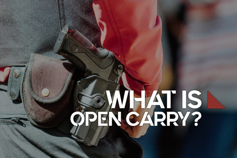 man demonstrating open carry with a pistol on his hop