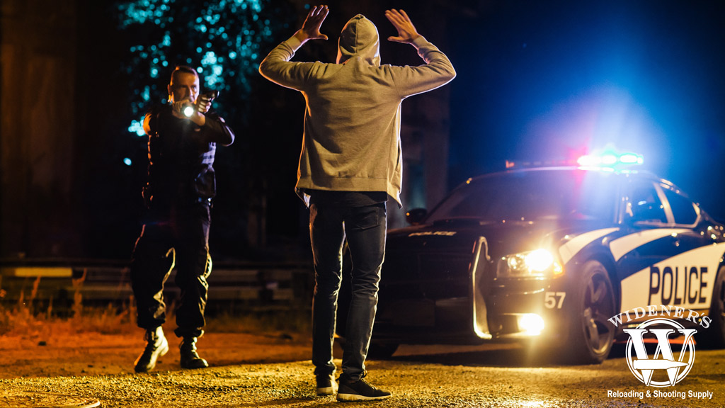 a photo of a police officer apprehending a suspect outside the kwik-e-mart