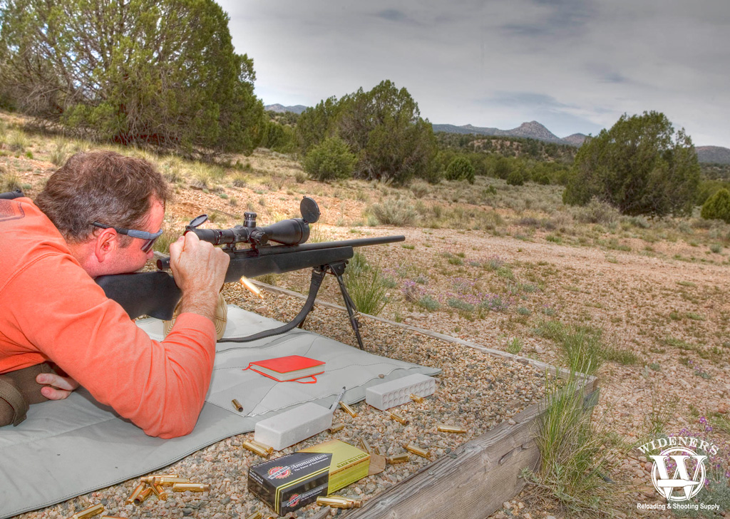 a photo of a man shooting a rifle outdoors
